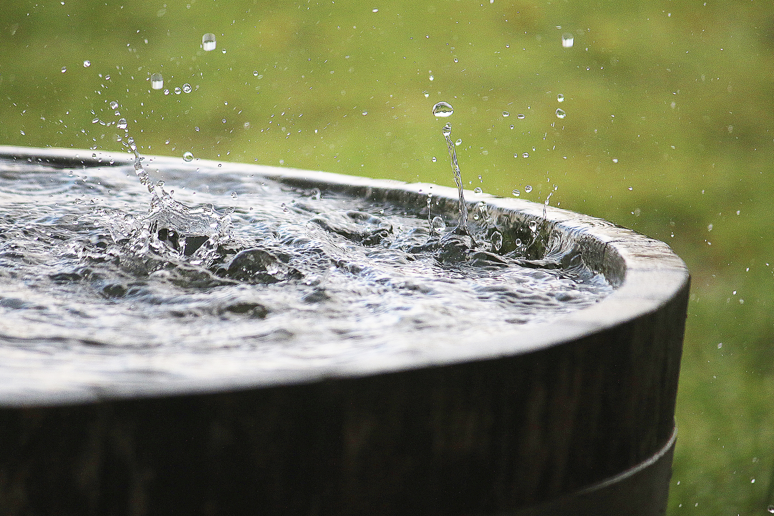 rain is falling in a wooden barrel full of water in the garden Sitness4D